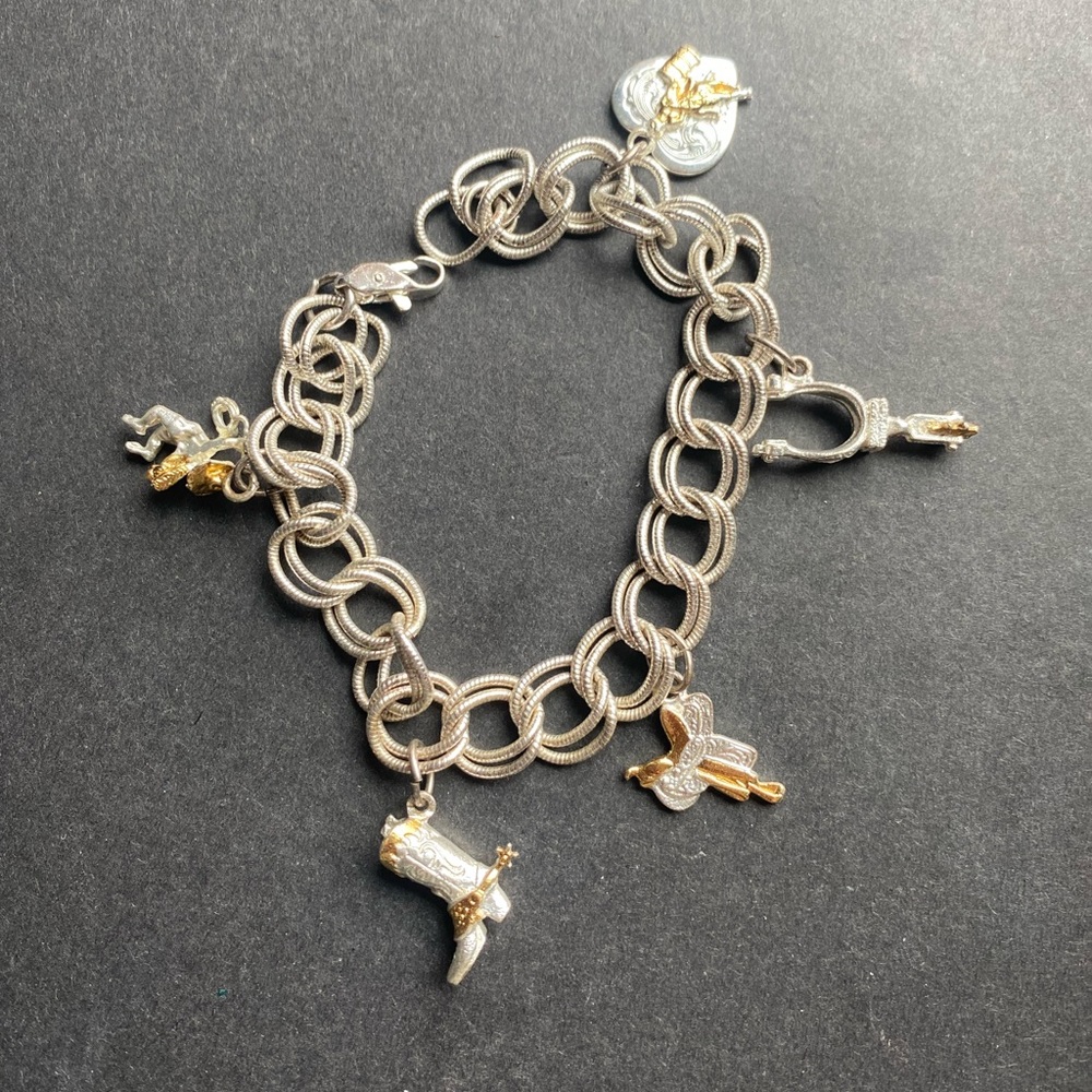 Western silver toned charm bracelet w/5 charms including cowboy boots, stirrups+